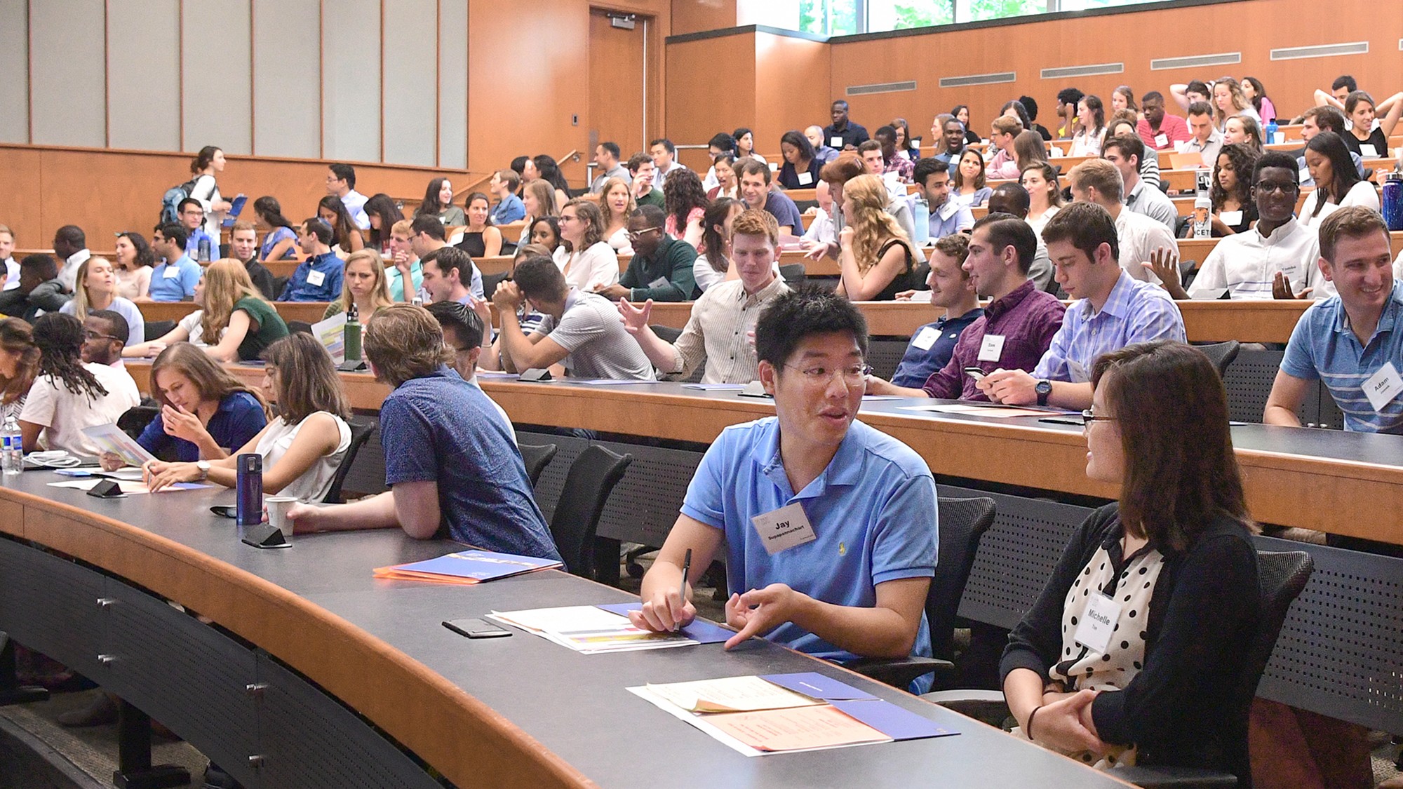 Group of medical students sitting in a lecture hall collaborating