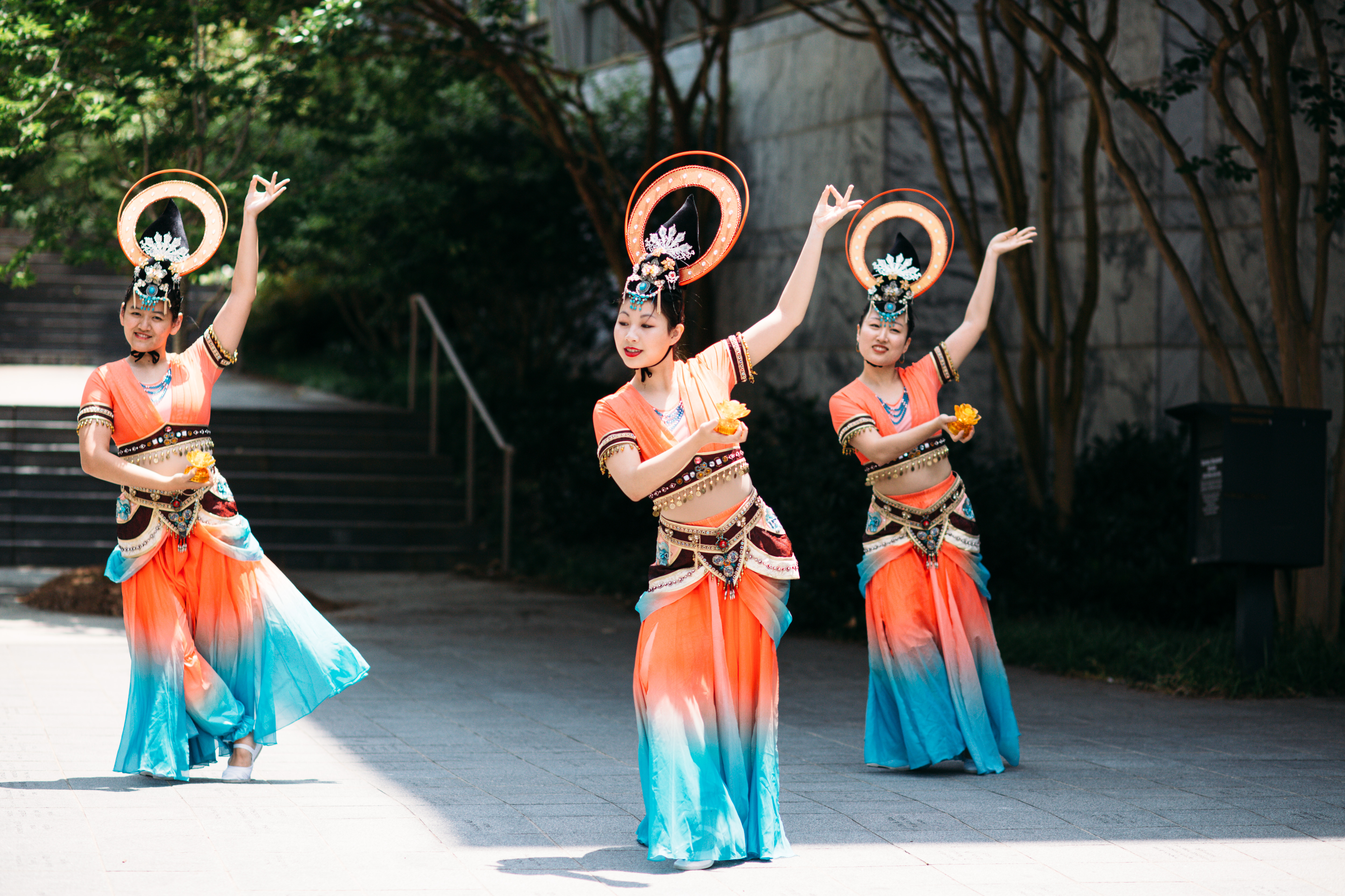 Traditional Chinese dancers wearing colorful blue and orange outfits
