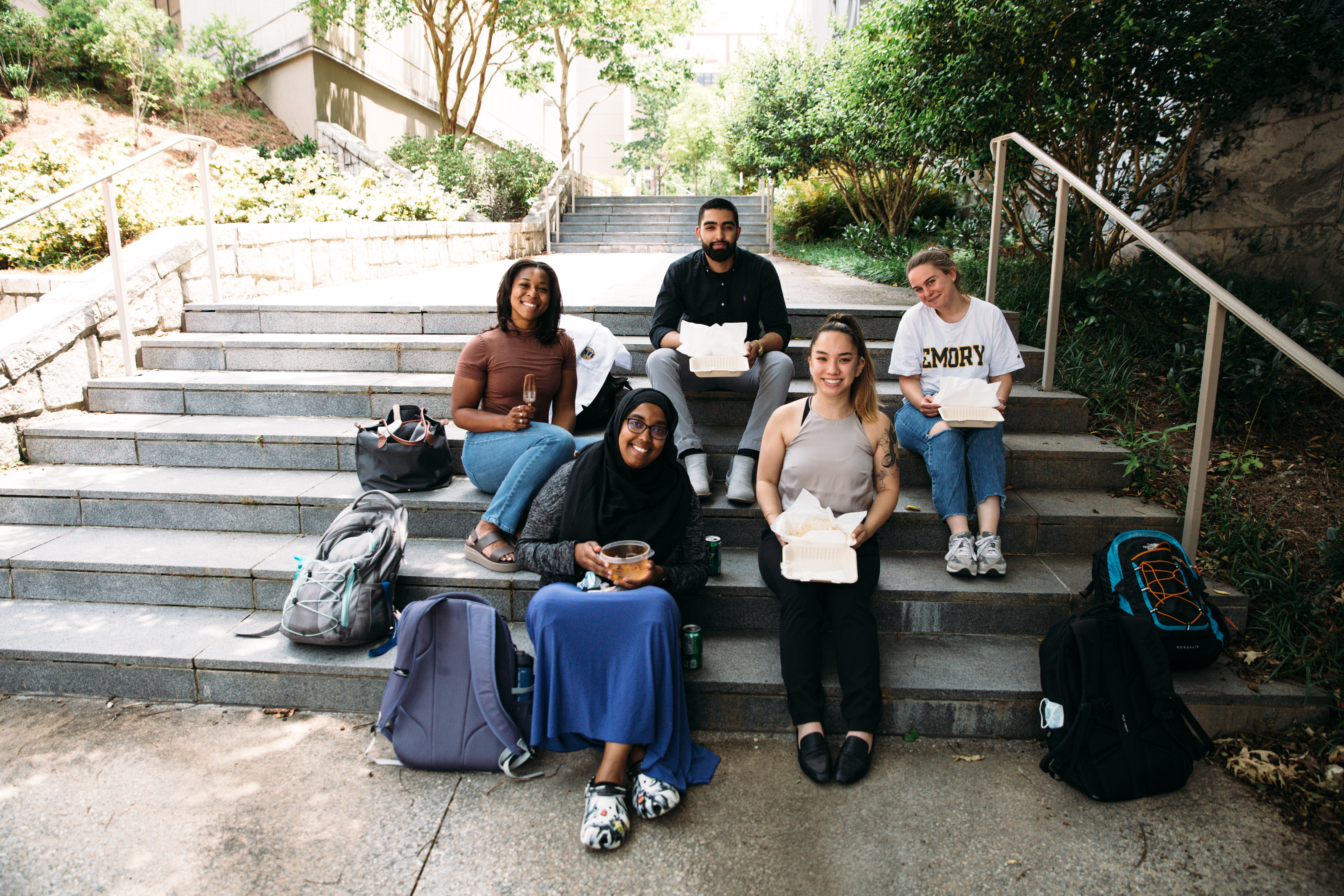 Group of students on steps eating together