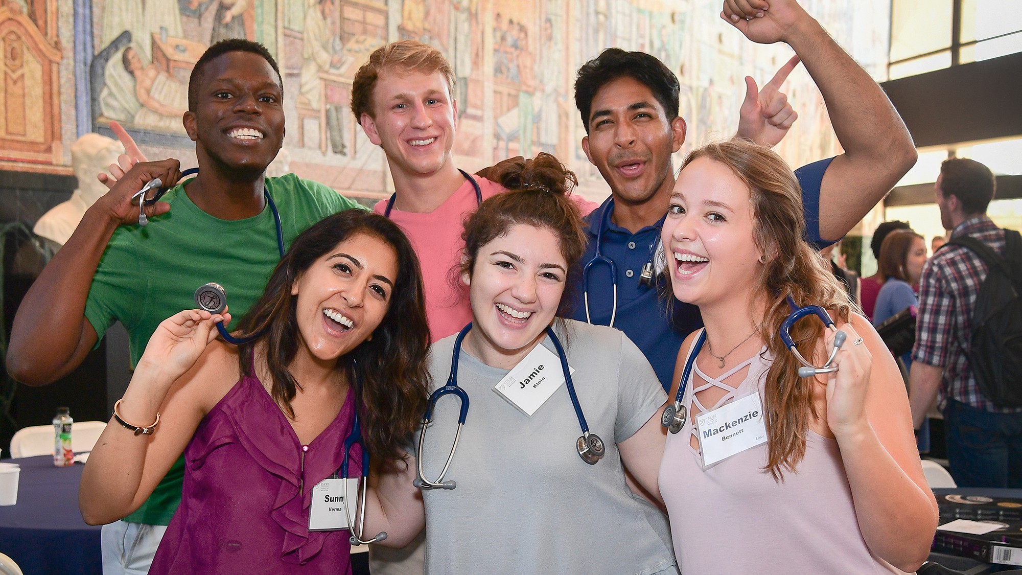 Group of medical students posing and smiling with stethoscopes