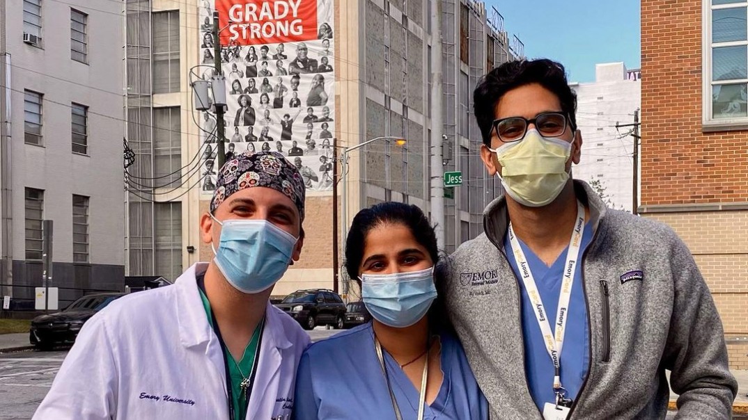 Three generations of Emory cardiology fellows standing outside wearing masks