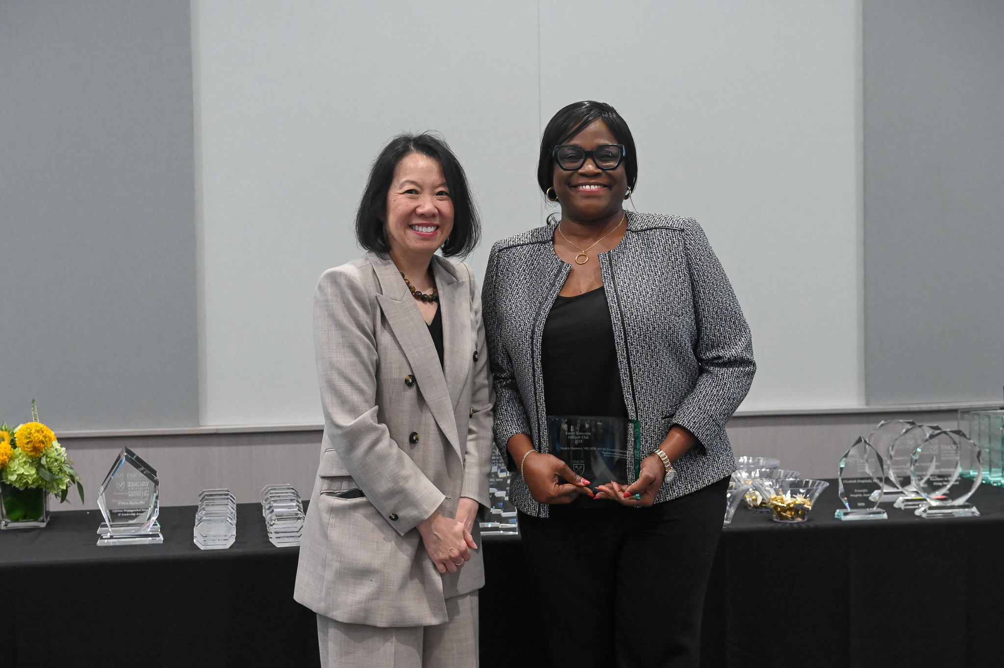 Faculty member receives glass award standing next to dean.