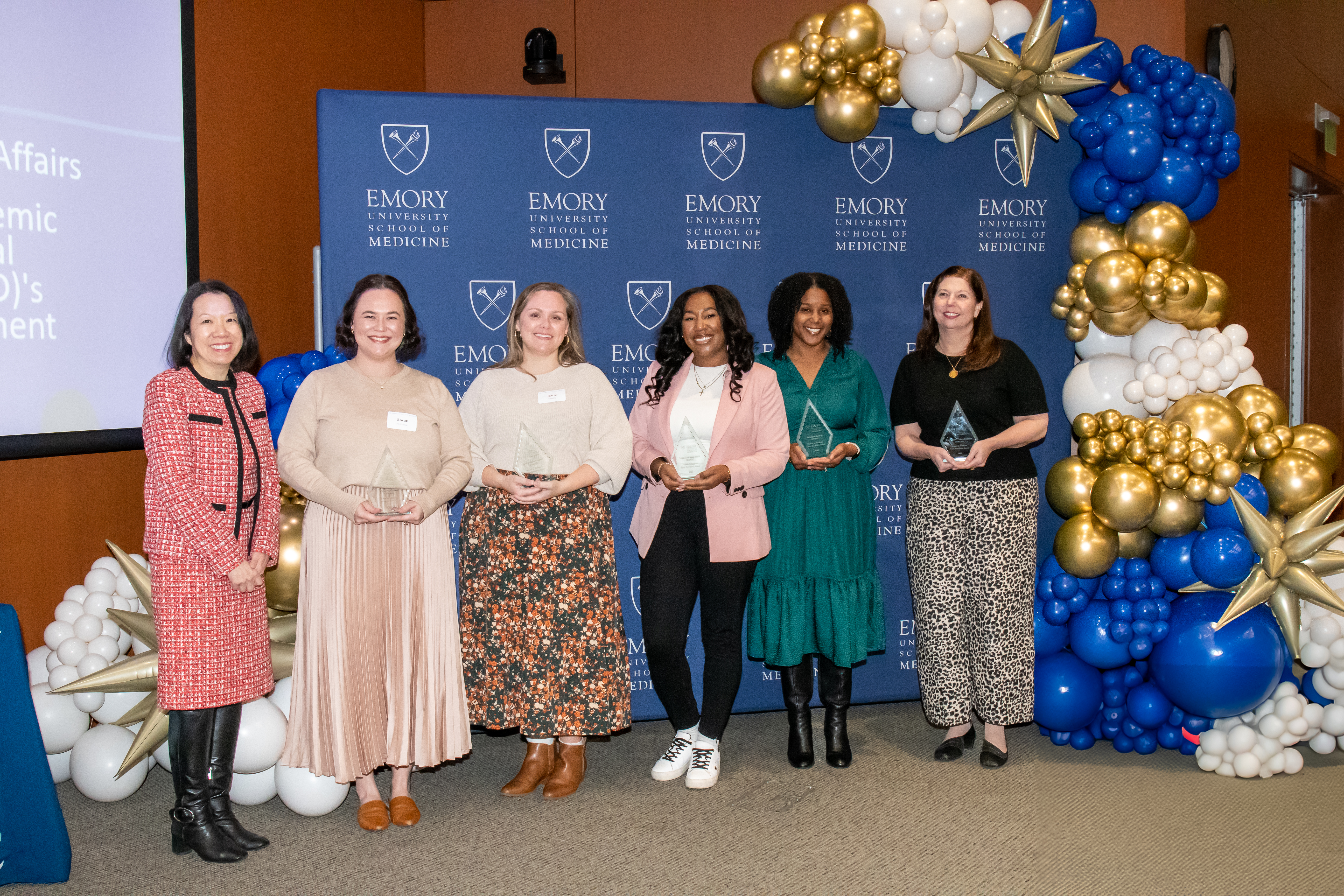 Office of Faculty Academic Affairs and Professional Development team smiles for a group photo with their awards.