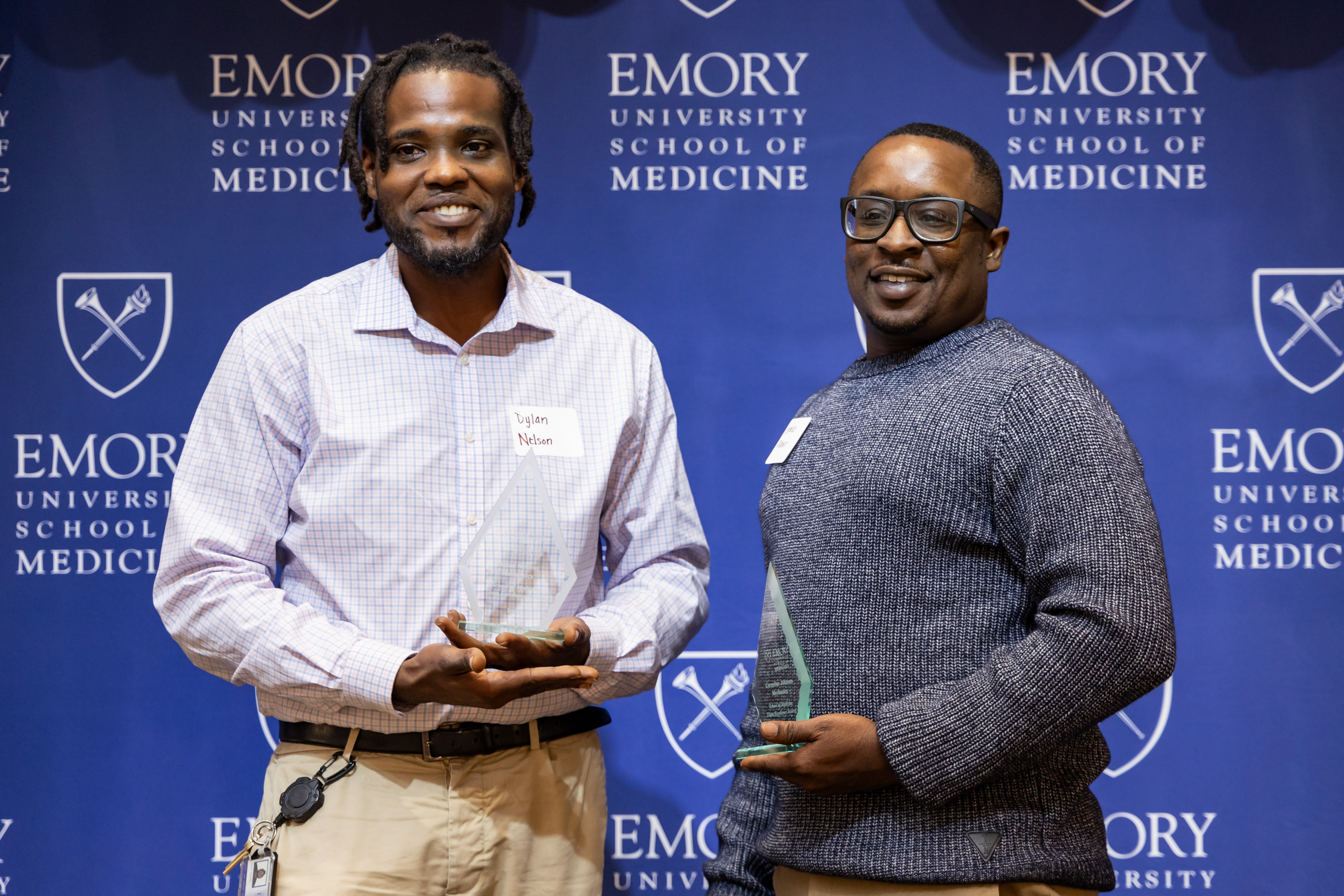 Cornelius Johnson and Dylan Nelson smile for a group photo with their awards.