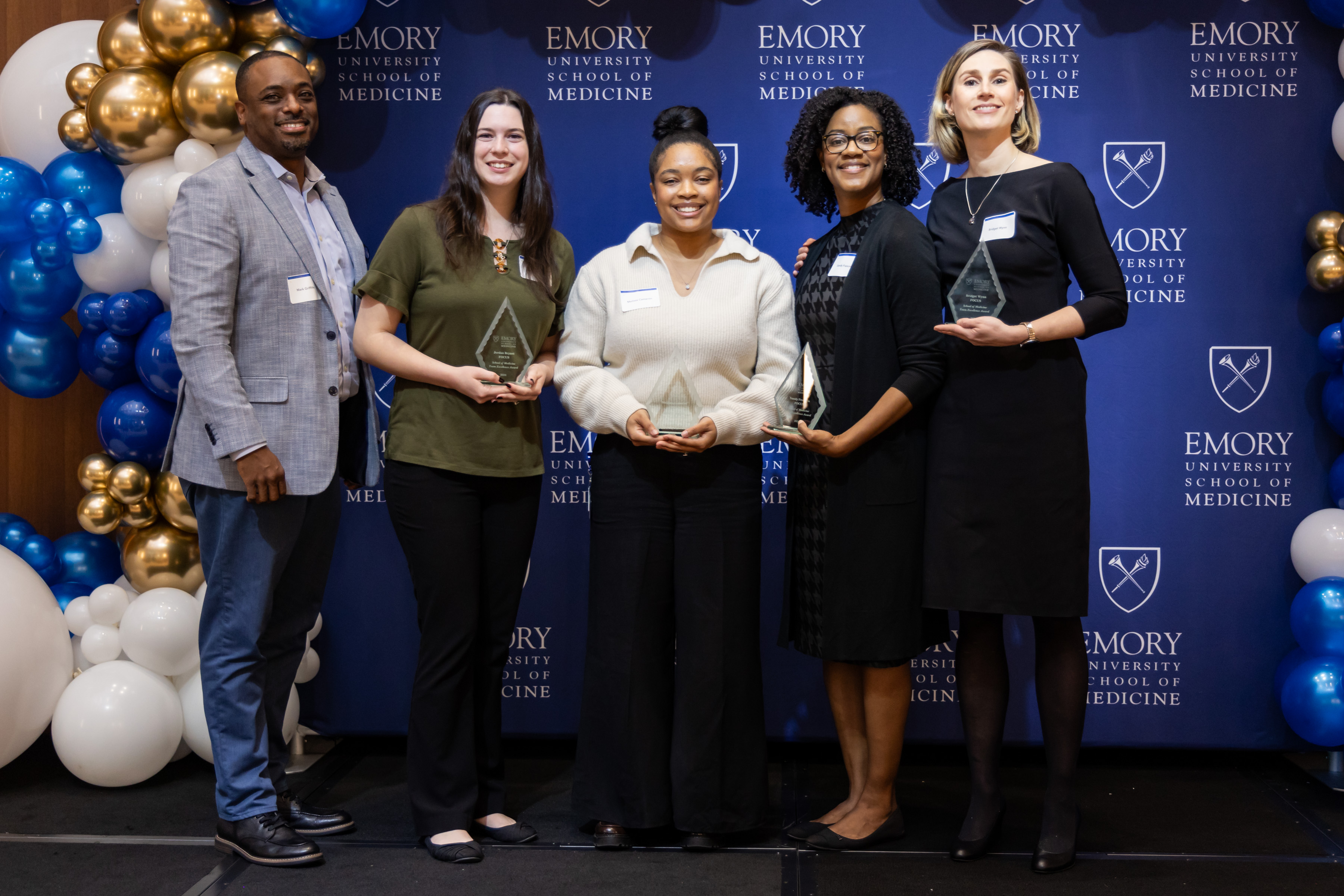 Department of Pediatrics: Frontlines of Communities in the United States (FOCUS)​ team members smile for a group photo with their awards.