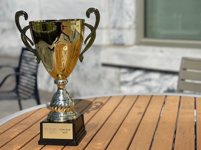 large gold trophy cup on an outdoor table