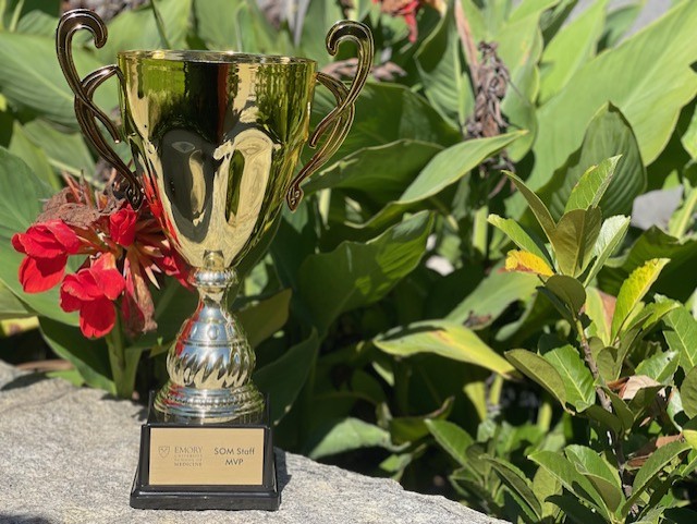 tall gold trophy next two red blooms
