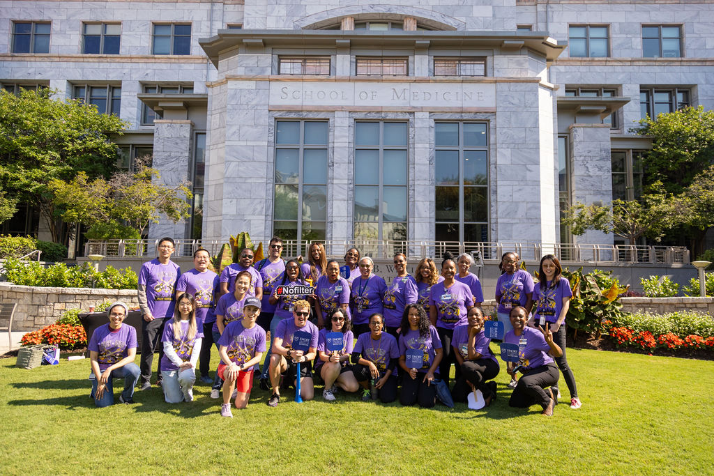 SOM Staff pose in front of James B. Williams Medical Education Building during Staff Appreciation Week 2024.