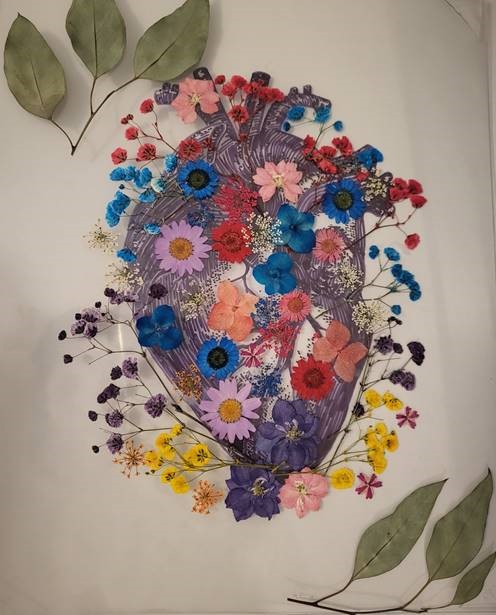 artwork in the of a heart with dried flowers attached