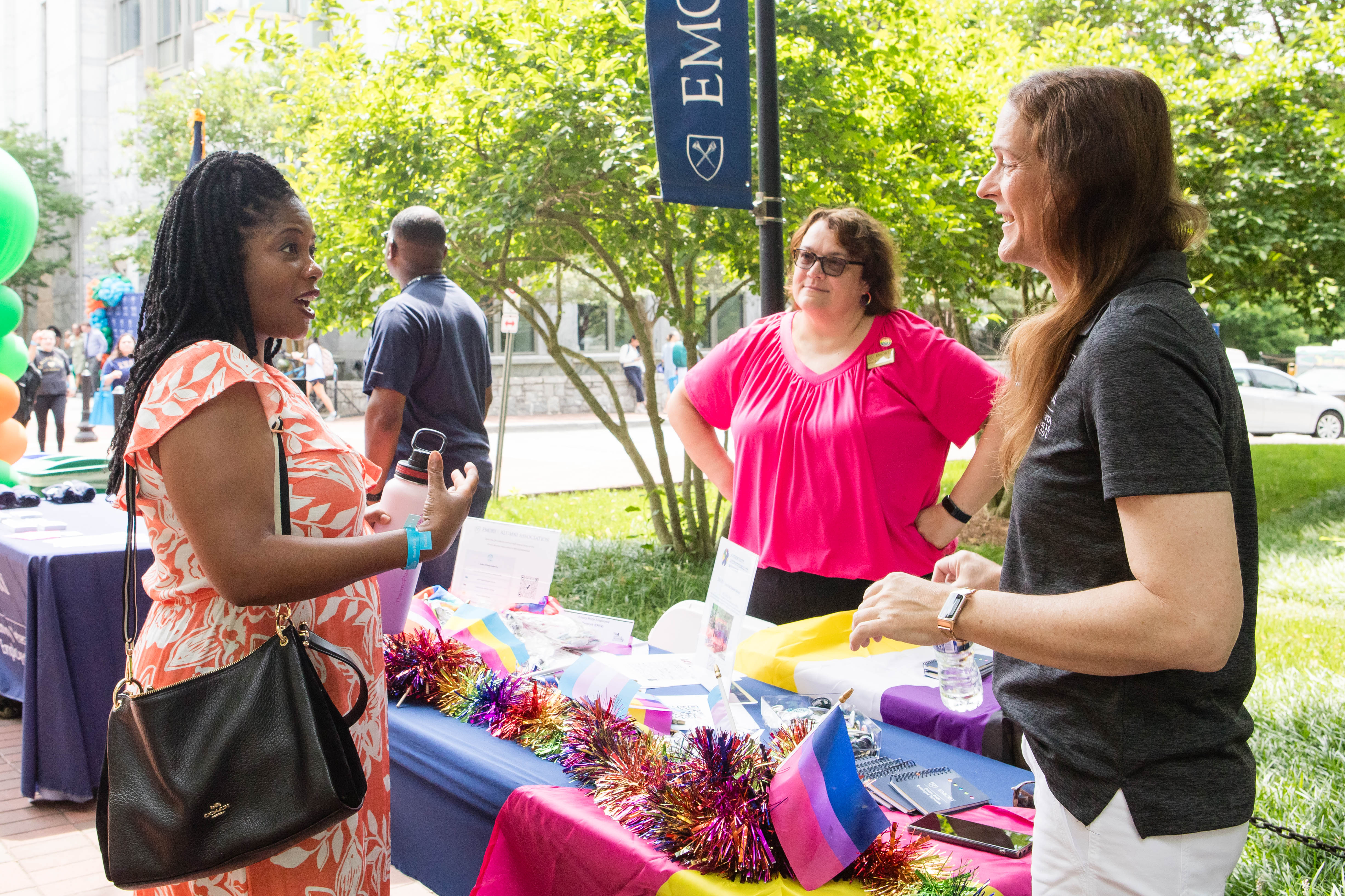 A man and a women stand behind a sign at Diversity and Inclusion Week.