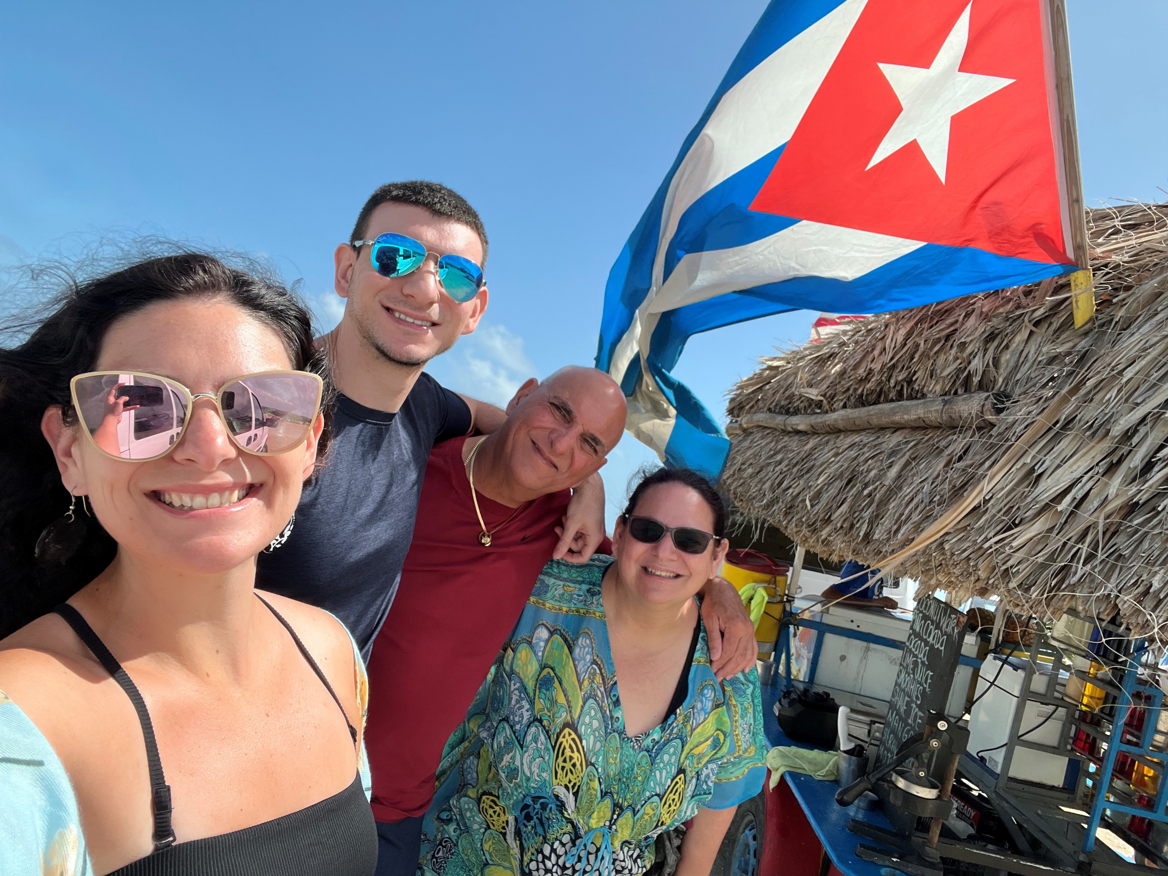 Dr. Fleites with family and Cuban flag