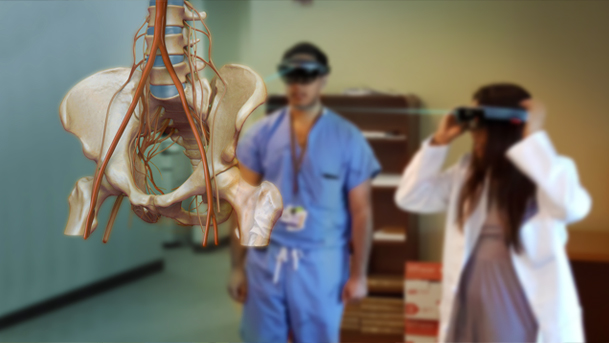 Simulation of surgical residents viewing pelvic anatomy on mixed reality headset.