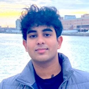 headshot of man standing near a body of water