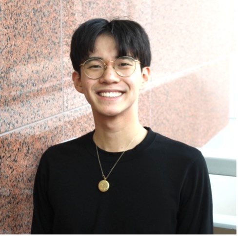 man standing in front of brick wall