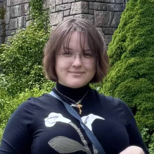 headshot of woman in black shirt