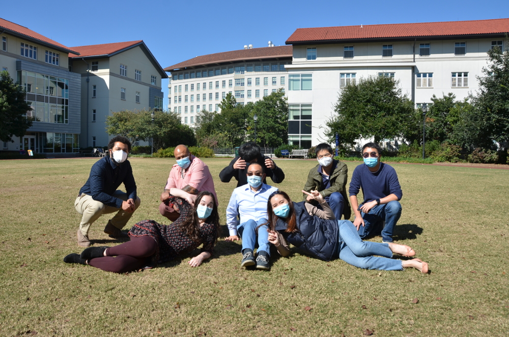 Liang Lab event image 2023, sitting on field on Emory campus