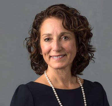 headshot of woman wearing black shirt and a necklace