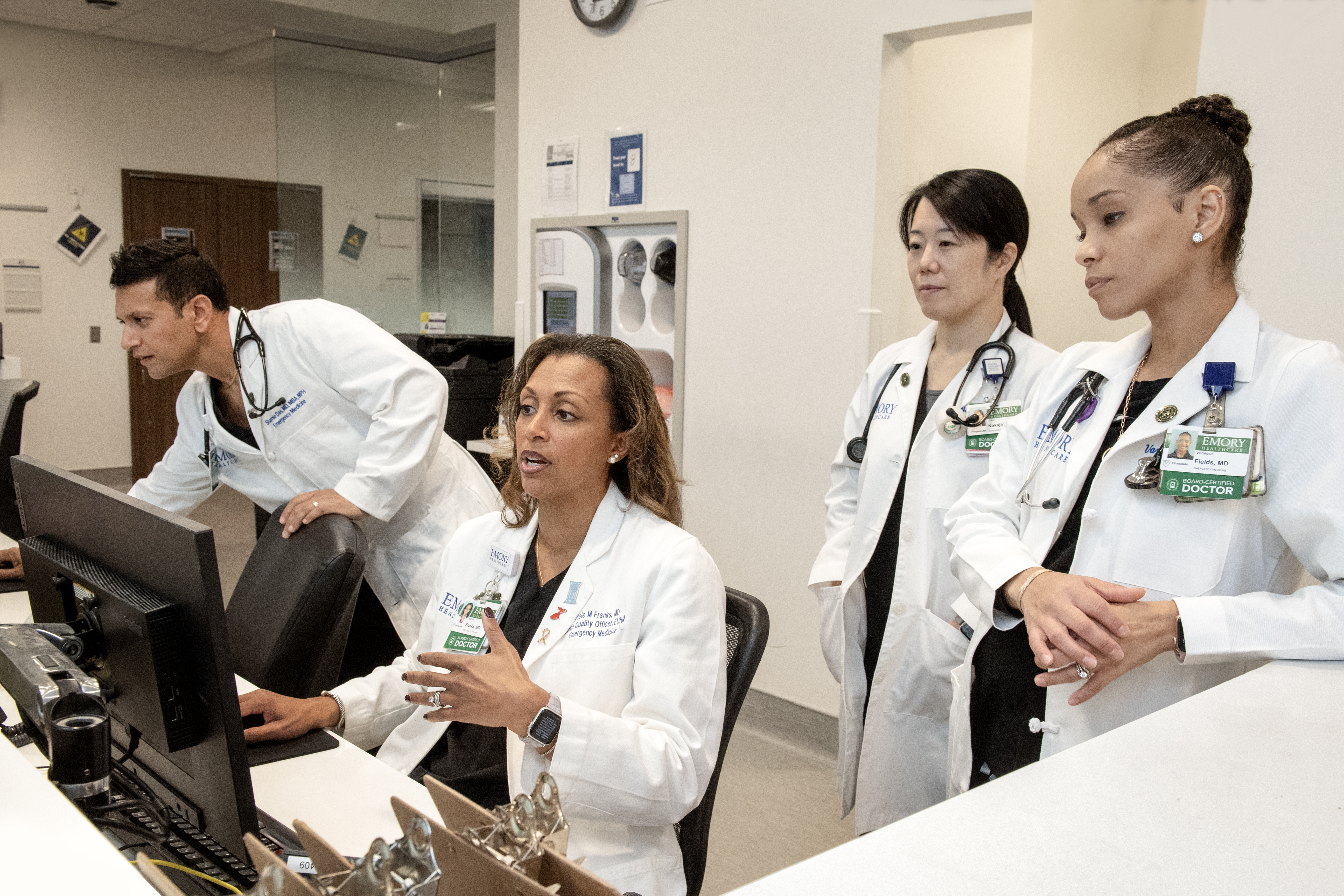 Dr. Das, Dr. Fields, Dr. Franks, Dr. Nakajima conferring