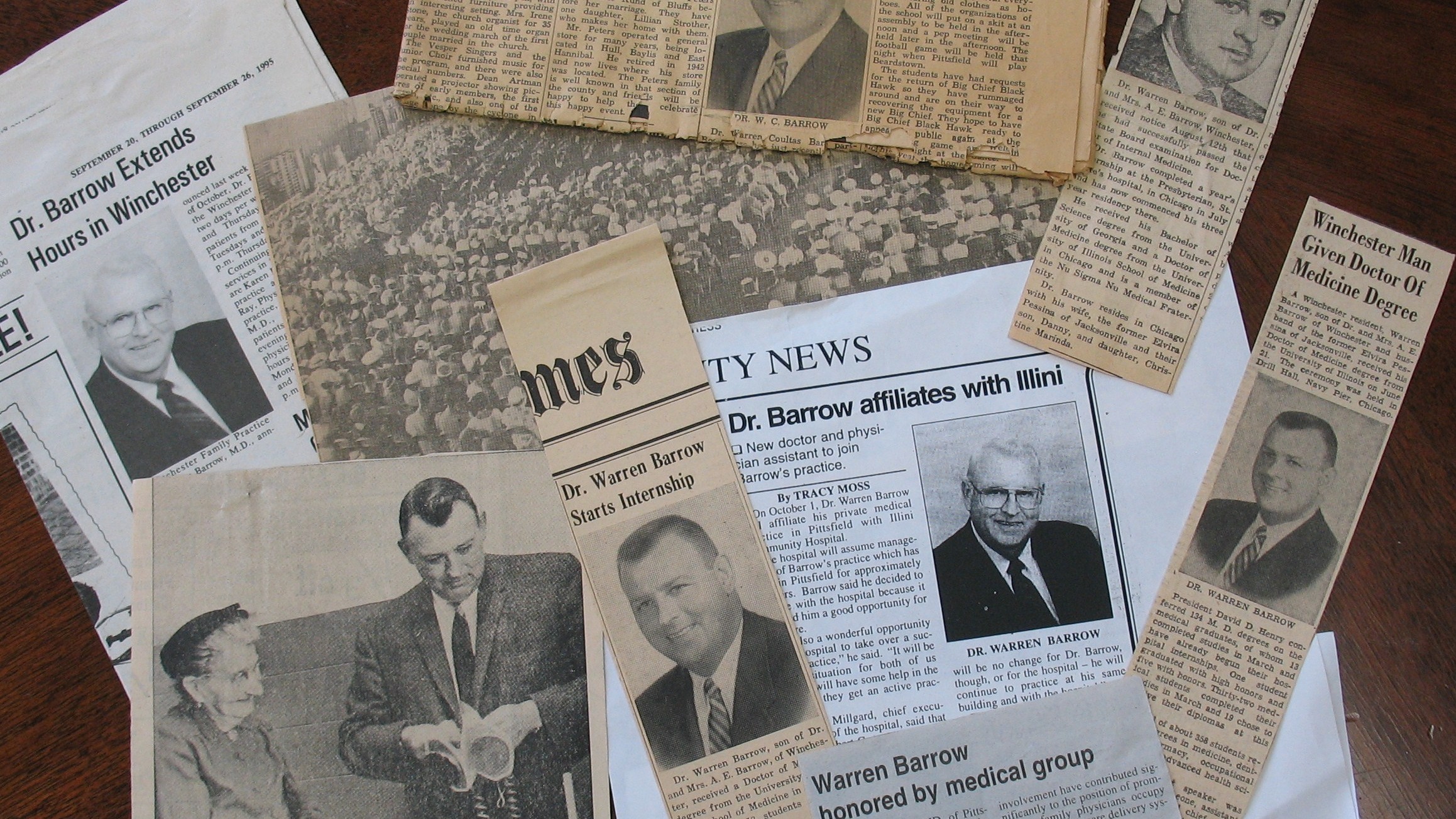 newslpaper clippings about Dr. Dan Barrow arranged on a flat surface