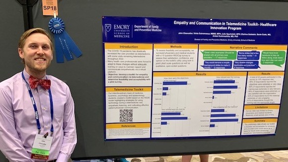 Emory MD student John Chancellor in front of a poster he presented at 2023 STFM Conference