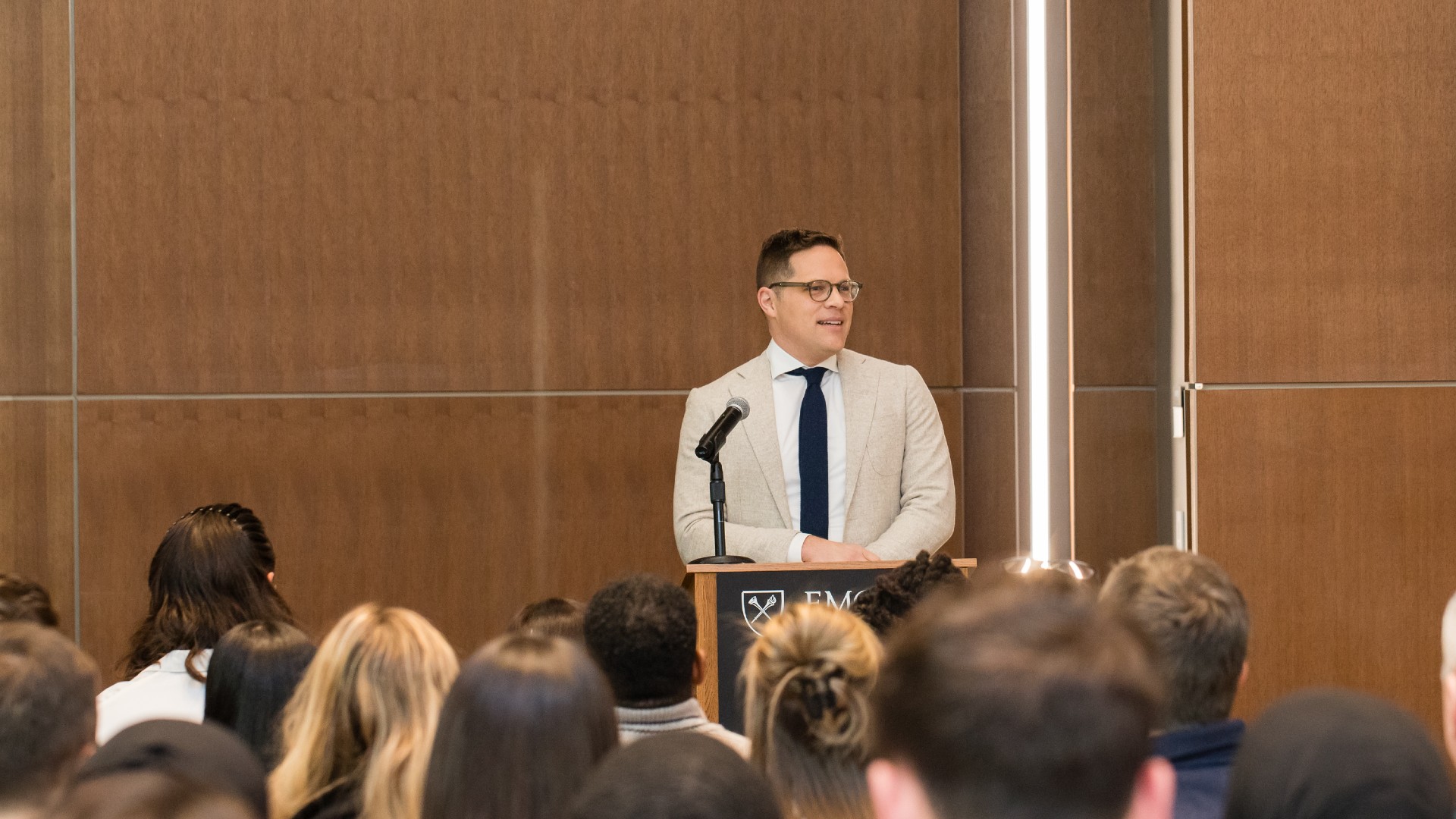 Alex Kendall, PA Program Director, speaking at a podium at the PA White Coat Ceremony