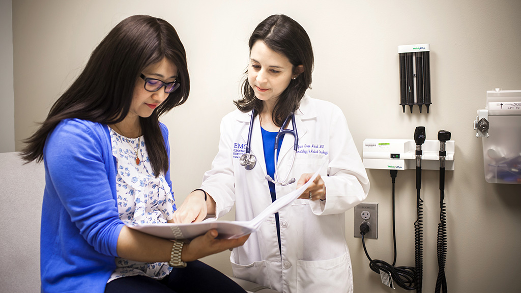 Jane Meisel, MD in the clinic room with patient.