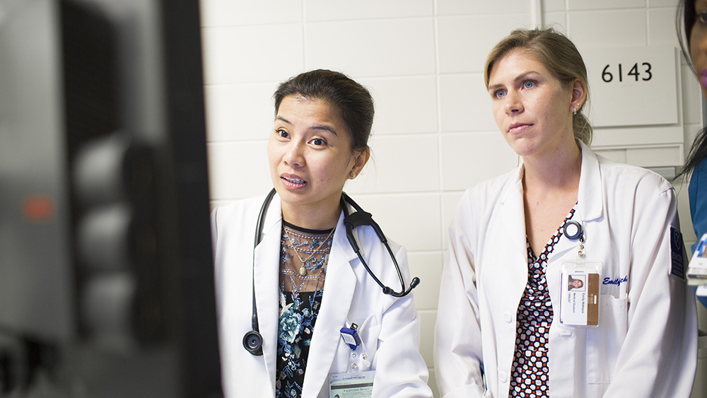 female physicians looking at screen
