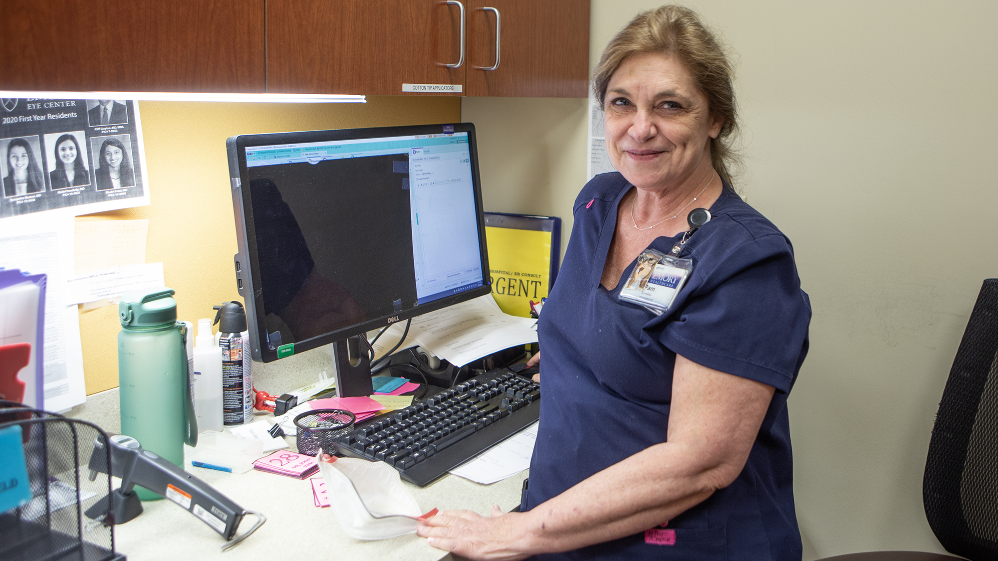 An Emory Eye Center patient care coordinator at her desk