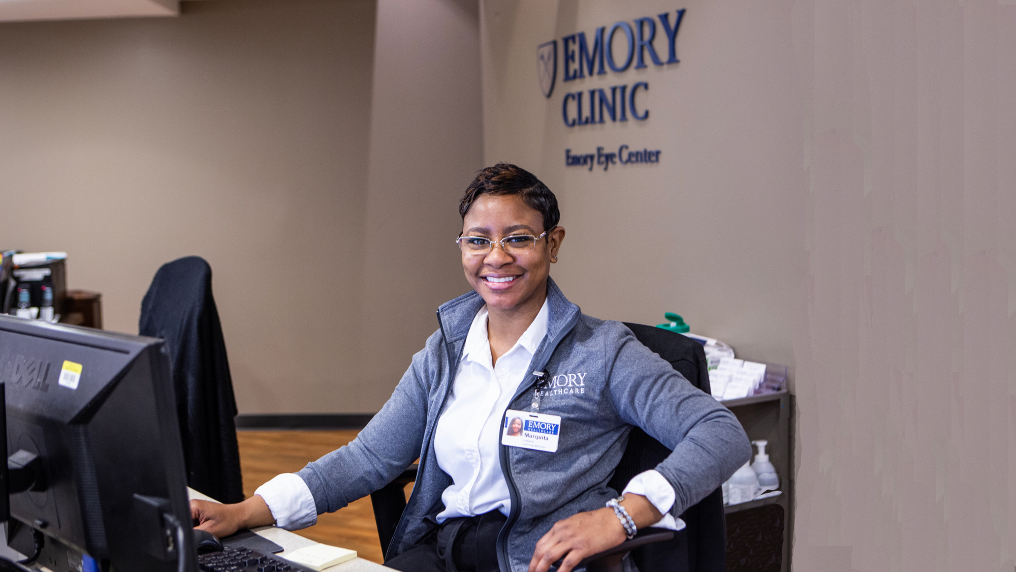 Front desk  check-in patient coordinator smiling at camera