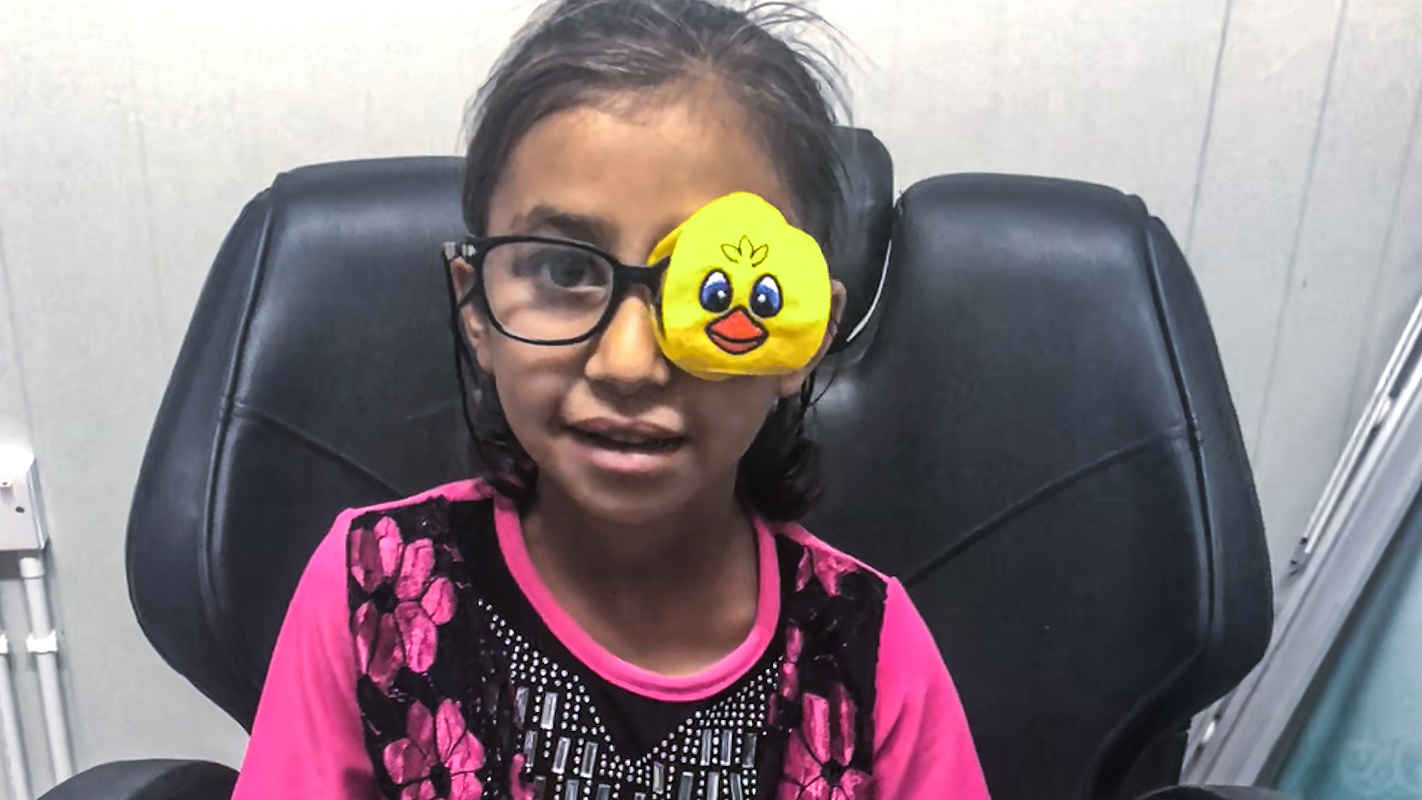 a little girl with a yellow patch over her eye 