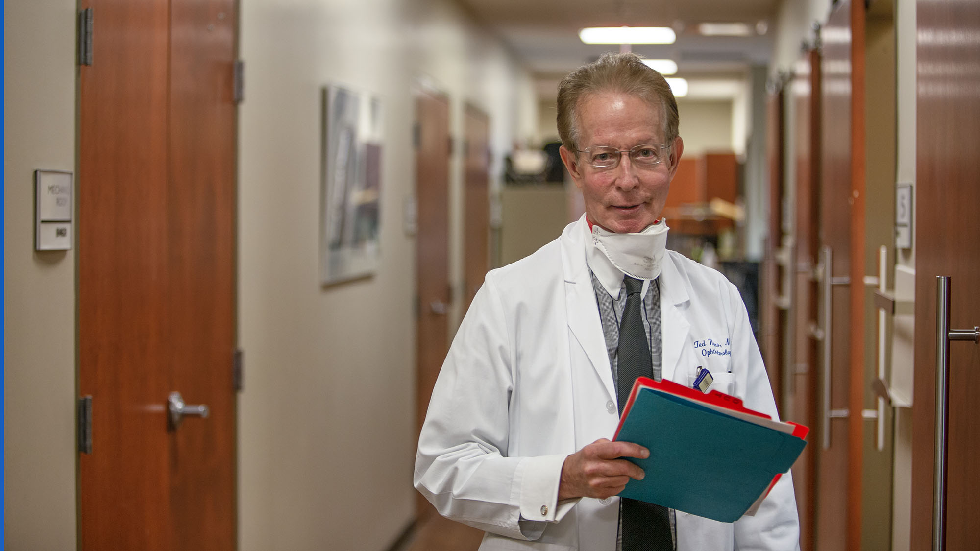 Dr. Ted Wojno, holding a patient file