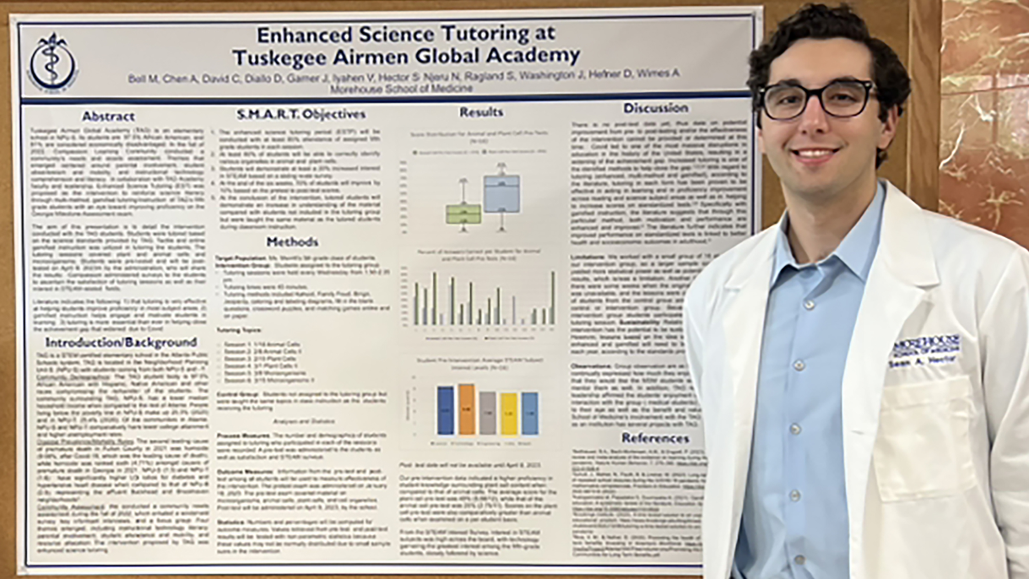 Sean Hector standing next to a research poster