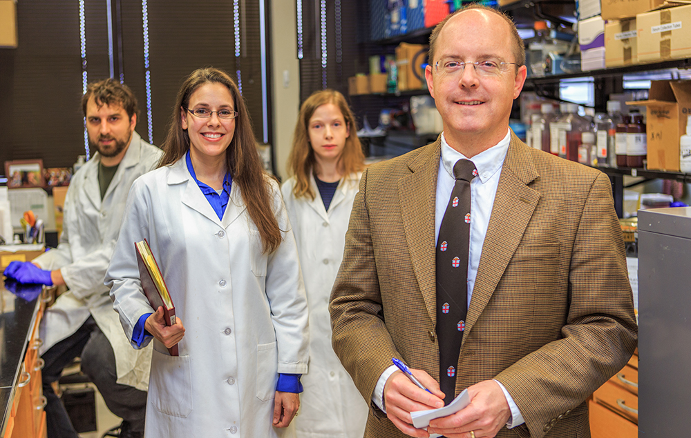 Dr.  Boatright with his researchers in their lab