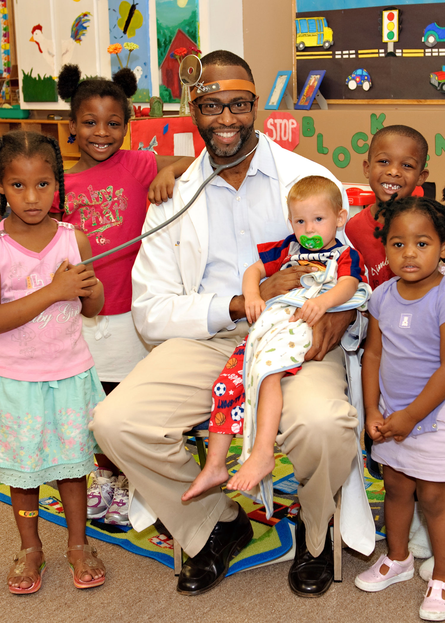 Dr. Charles Moore with pediatric patients at the Healing Community Center.