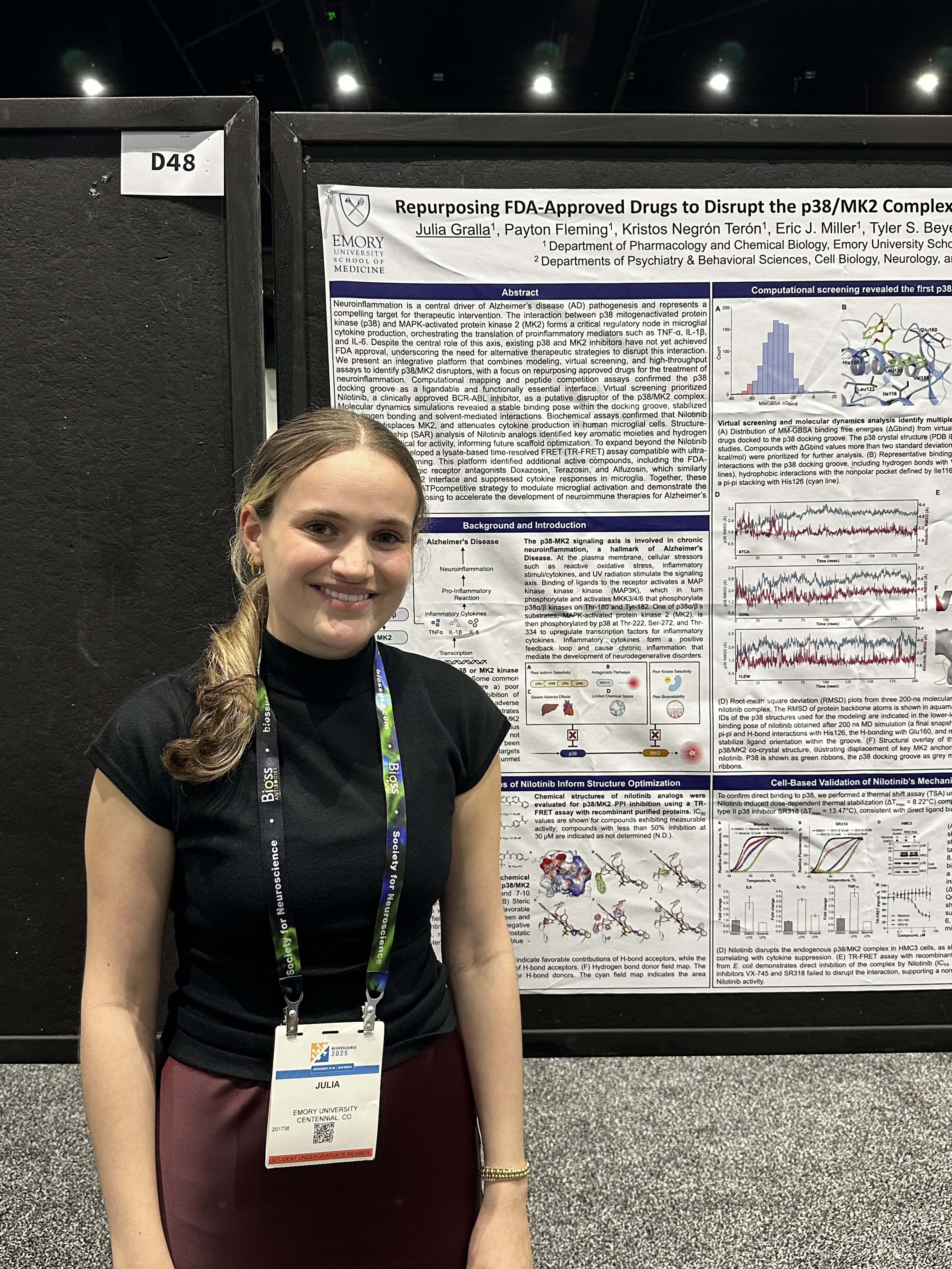 woman standing in front of poster presentation