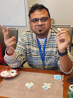 Nayem decorating holiday cookies.