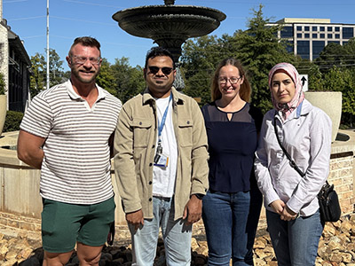 Orthwein lab team outside in front of a fountain.