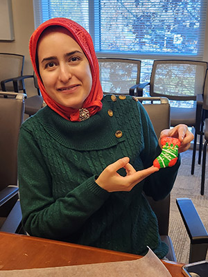 Ramona holds up a decorated holiday cookie.