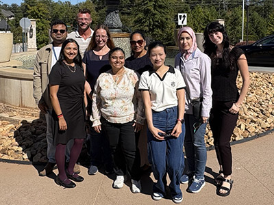 Kesarwala lab team and Orthwein lab team members outside in front of a fountain.