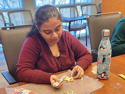 Mithila decorates a holiday cookie.
