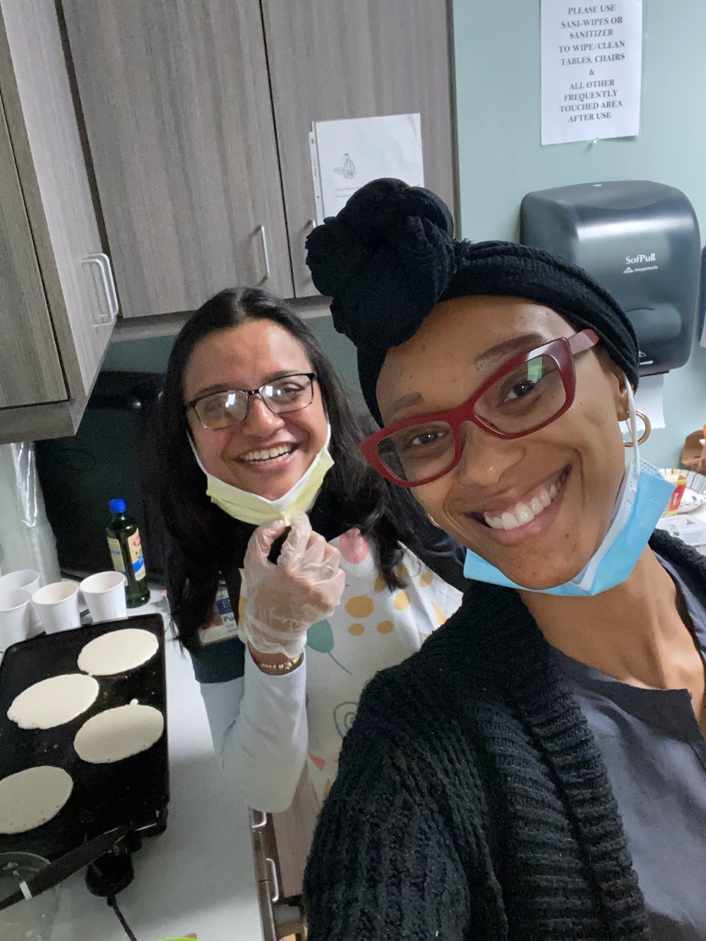 two smiling women making pancakes