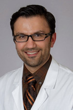 smiling person wearing white doctor coat