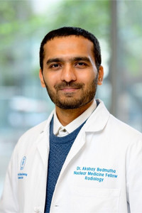 smiling person in doctor coat