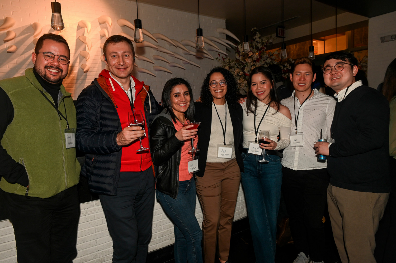 people smiling and standing in a line at a party