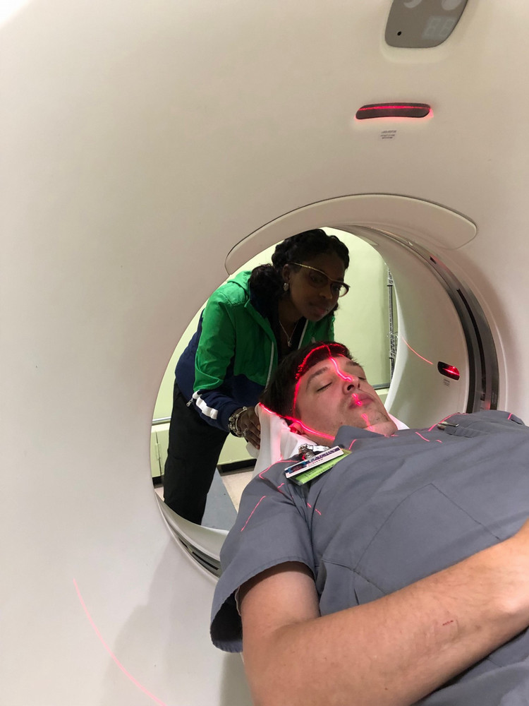student looking at guidelines for ct patient placement