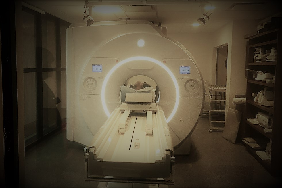 large MRI PET scanner with person's head visible