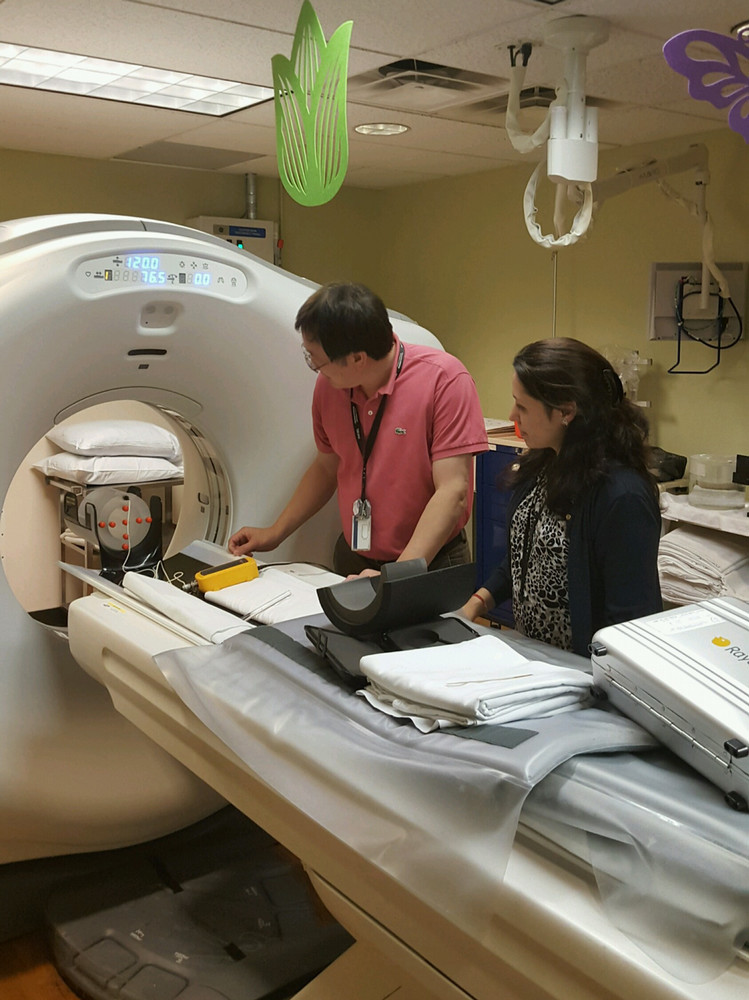 two people testing a CT imaging machine