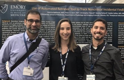 three people standing in front of an academic poster about using automated retrieval tools to track noncritical incidental findings in imaging