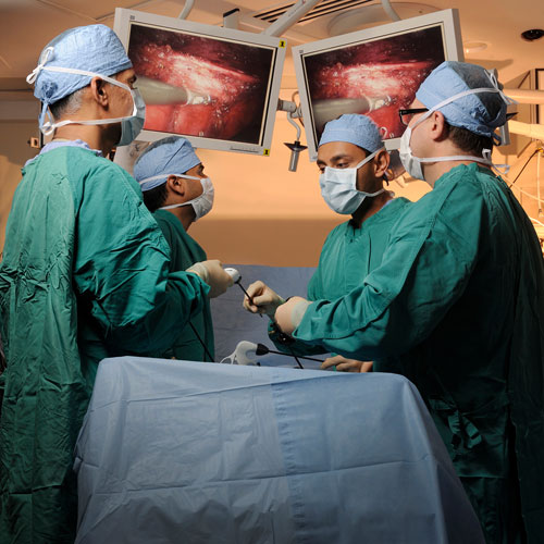 Surgical oncology team performing a procedure.