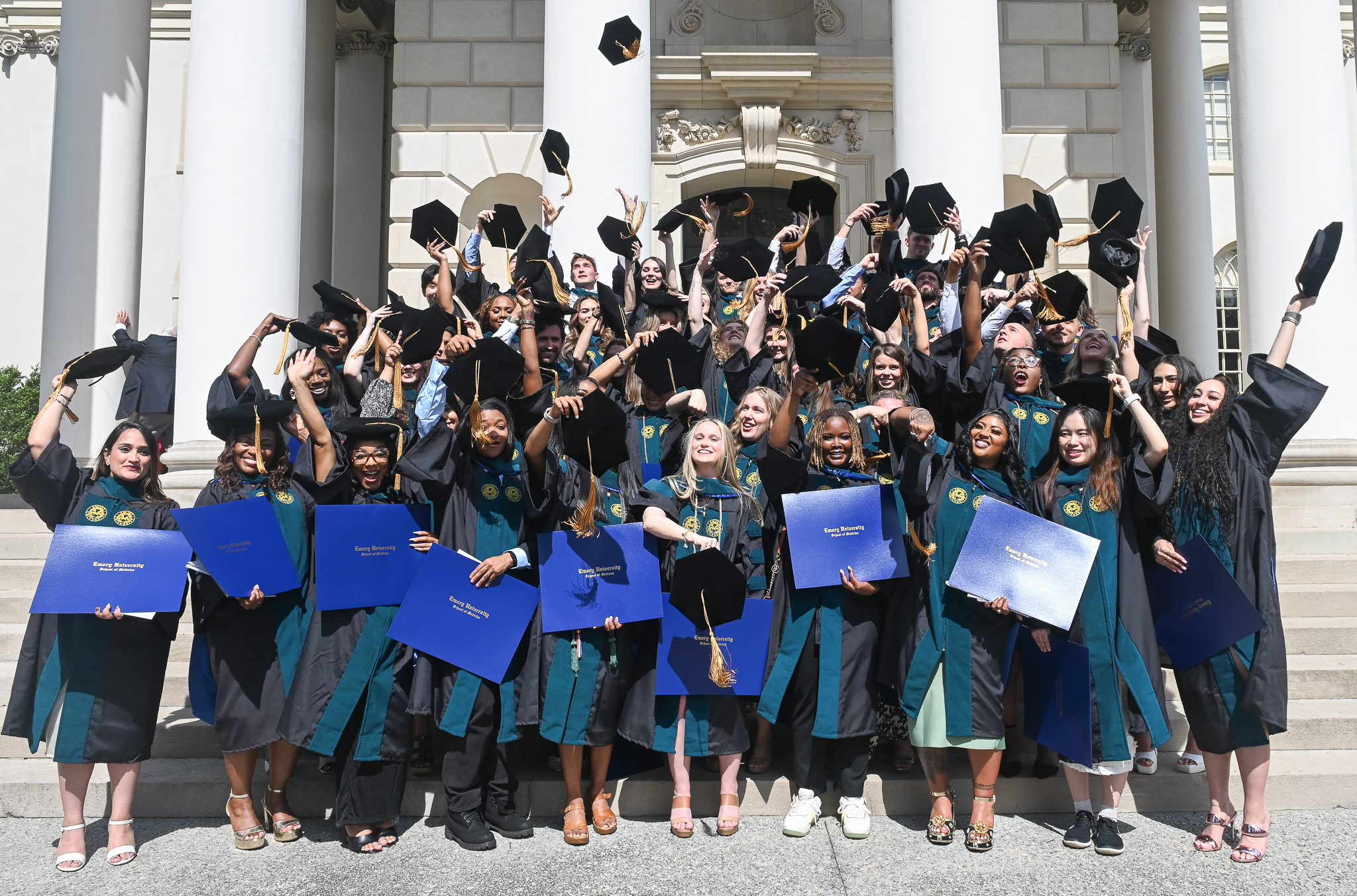 DPT Class of 2025 tosses diplomas in celebration.